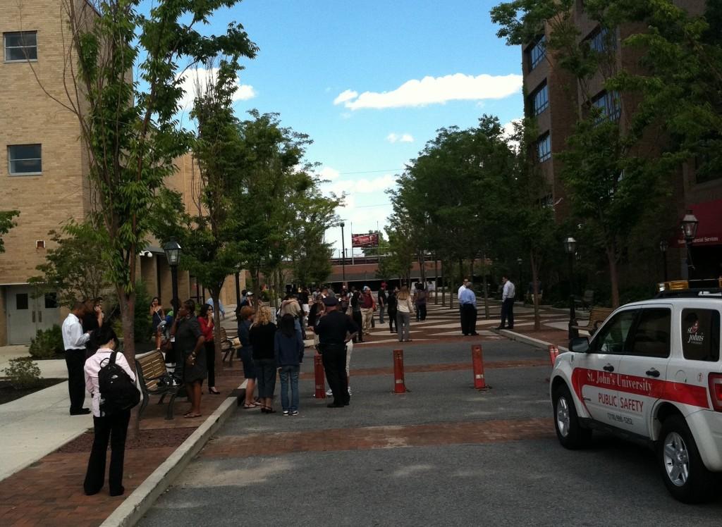 People gather outside Carnesecca Arena after evacuating Campus buildings in the wake of an earthquake.