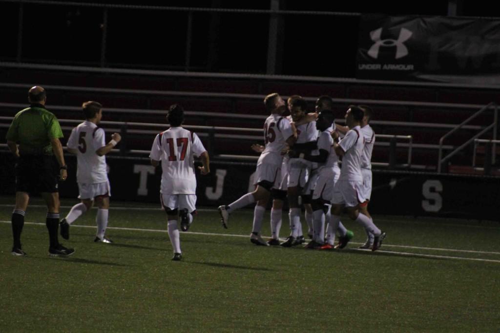 Casey Osborne celebrates with his teammates after scoring a goal. 