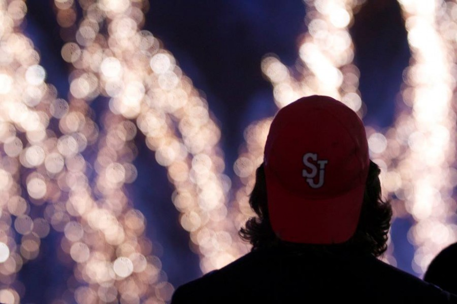 Student looks up at fireworks during the Dec. 7 Christmas Light Spectacular event.  