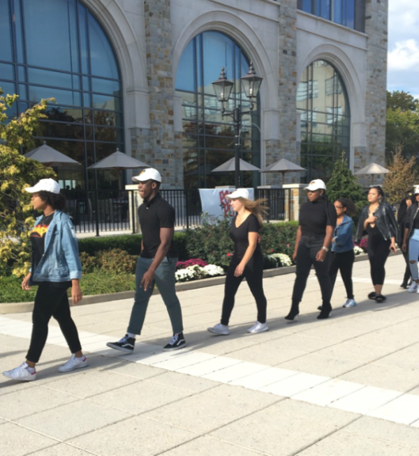 Red House members marched from Lourdes Hall to DAC in a straight line of all-black and white caps.