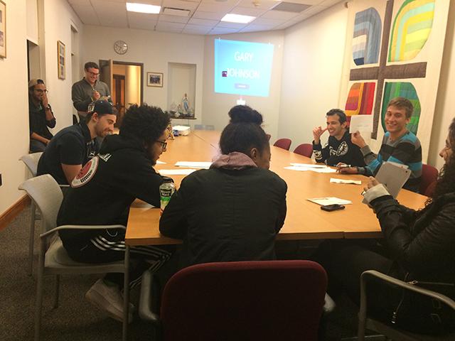 Students playing political jeopardy at the second debate watch party held in the St. Thomas More Church.