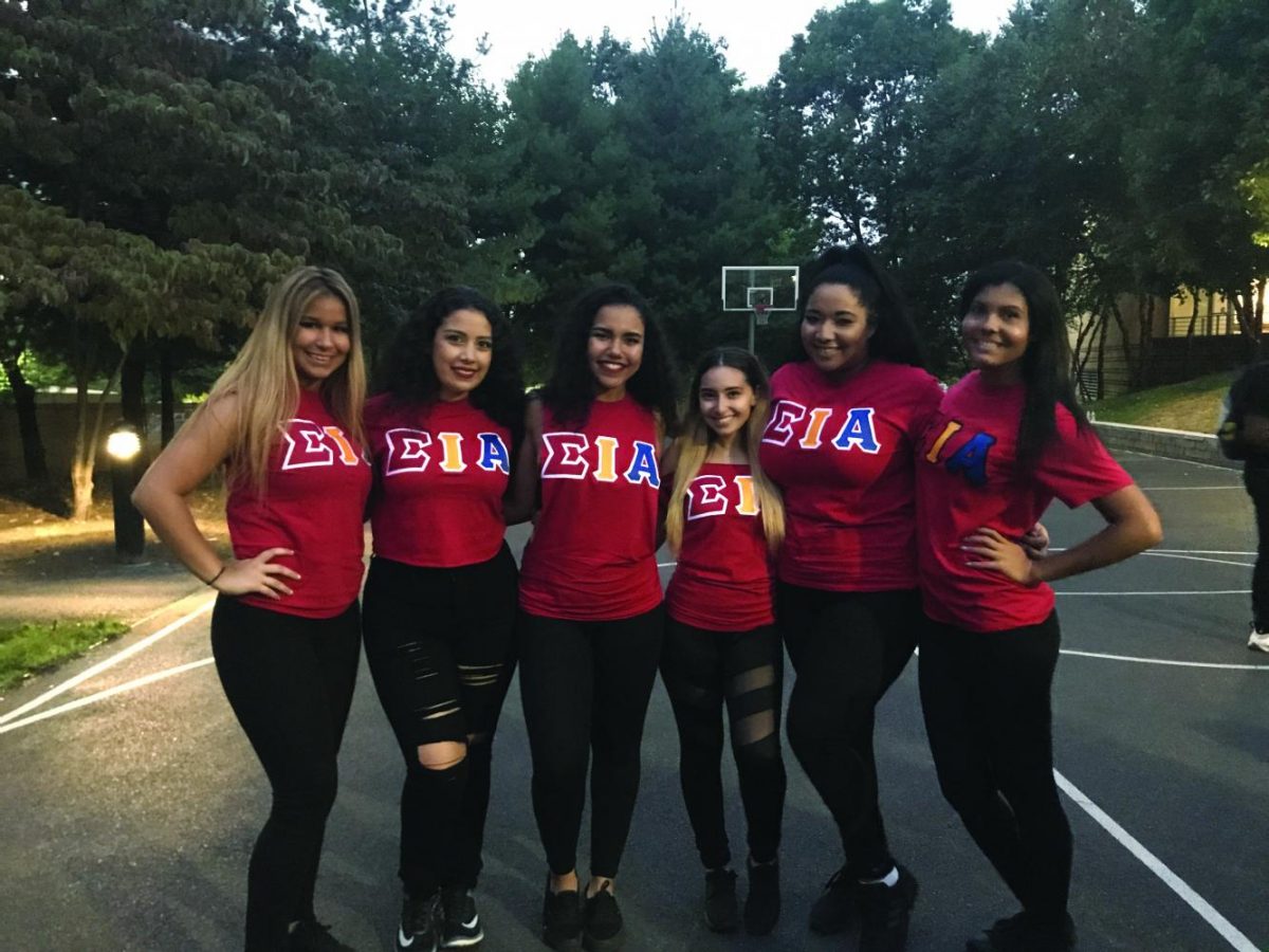 Sorority sisters of the Alpha Theta Chapter of Sigma Iota Alpha pose on the basketball court near Montgoris’ Patio.