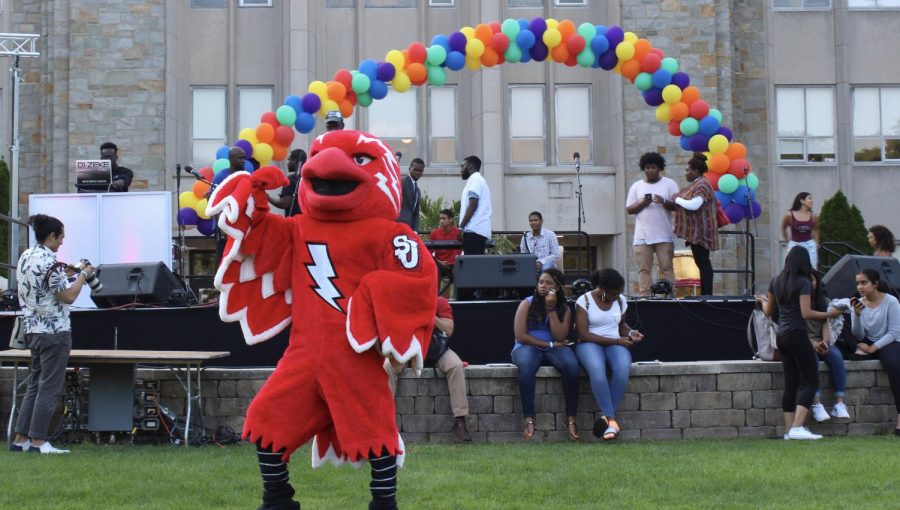 St. John’s University mascot, Johnny, dancing on the great lawn during the September 2017 multicultural mixer
