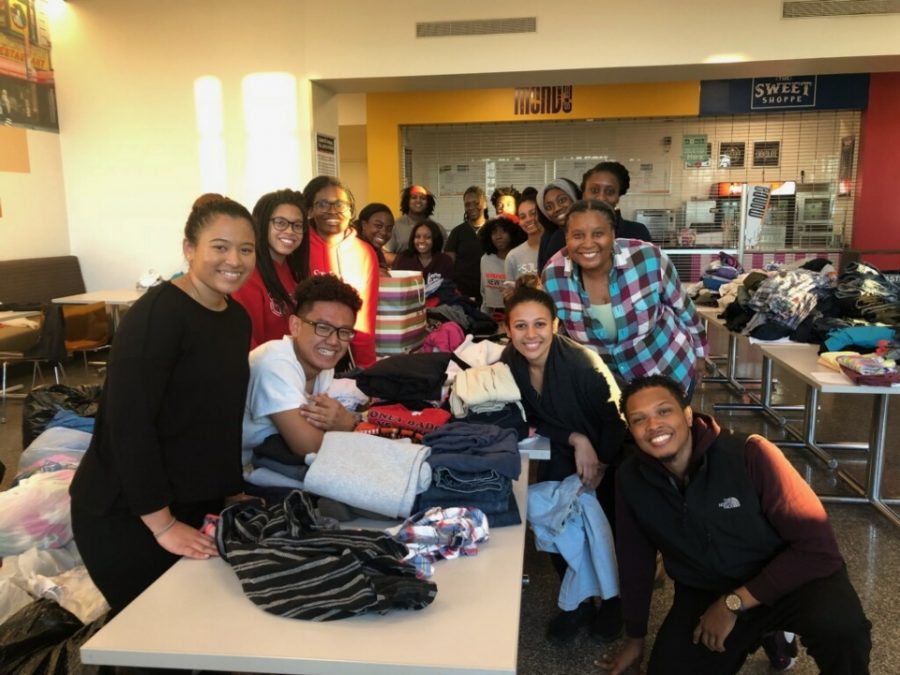 Seraiah Romero and volunteers from Eden and CSA sort clothes for easy distribution.