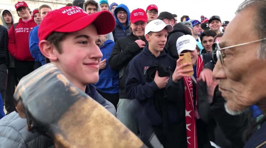 A screenshot of the interaction between Nick Sandmann of Covington Catholic High School and Nathan Phillips elder of the Omaha Tribe. 