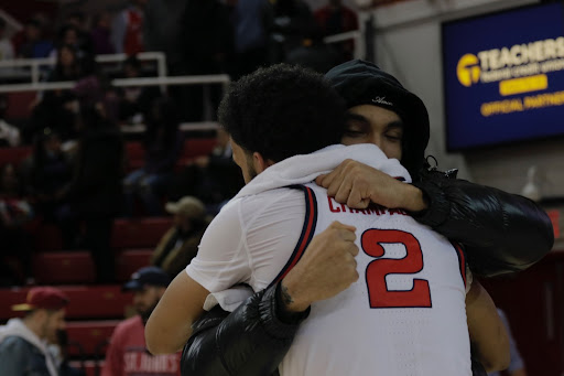 Julian and Justin Champagnie embrace each other on the court. 
TORCH PHOTO / Sara Kiernan
