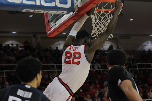 Esahia Nyiwe hangs from the rim in Carnesecca Arena. 