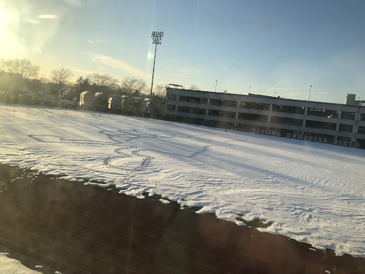 Picture of the field behind DAC that someone drew a walking thumbs up in the snow.