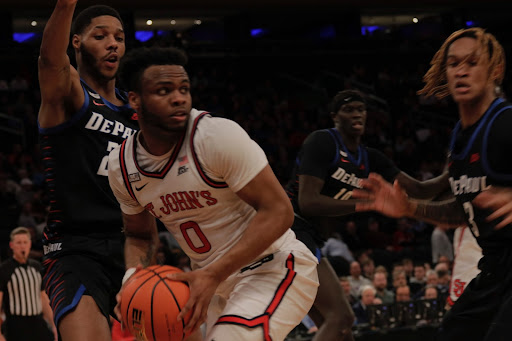 Posh Alexander moves under the basket against DePaul defenders.