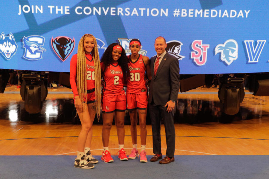 Three St. Johns Womens Basketball players take a photo with head coach Joe Tartamella at Big East Media Day.
Torch Photo / Sara Kiernan
